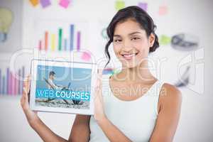 Composite 3d image of happy businesswoman showing digital tablet in creative office