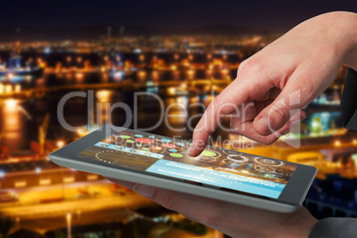 Composite 3d image of businesswoman hand using digital tablet