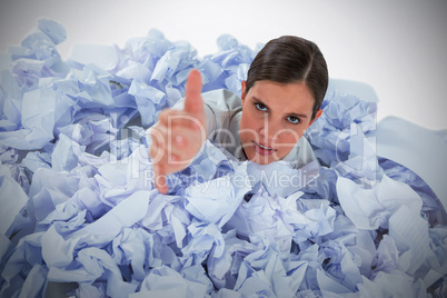 Composite image of conceptual image of woman in heap of crumple paper asking for help