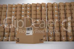 Composite image of open cardboard box against pile of boxes