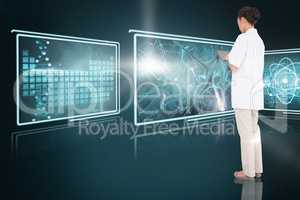 Composite 3d image of pretty nurse using tablet pc