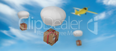 Composite image of 3d digital image of parachute carrying cardboard box