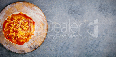Fresh pizza on wooden cutting board