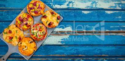 Pizzas arranged on wooden table