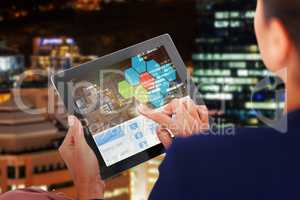 Composite 3d image of businesswoman working on digital tablet over white background