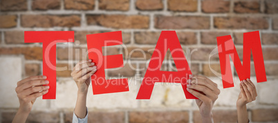 Composite image of cropped hand of businesswoman holding letter m