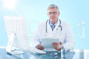 Composite 3d image of portrait of confident male doctor sitting at computer desk