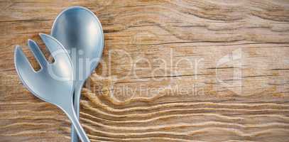 Spoon and fork on wooden table