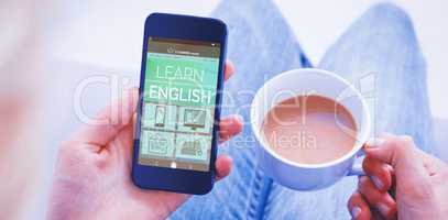 Composite 3d image of woman using her mobile phone and holding cup of coffee