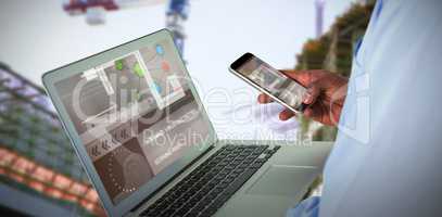 Composite 3d image of businessman using mobile phone and laptop