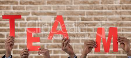 Composite image of cropped hand of businessman holding alphabet a