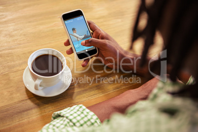 Composite 3d image of businessman learning on the beach