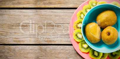 Kiwi fruits arranged on wooden table