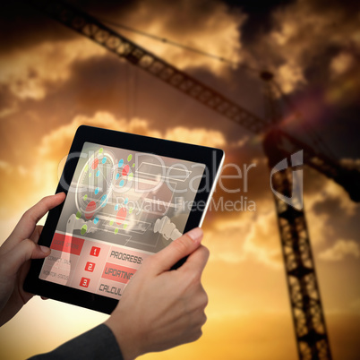 Composite 3d image of cropped image of businesswoman holding digital tablet