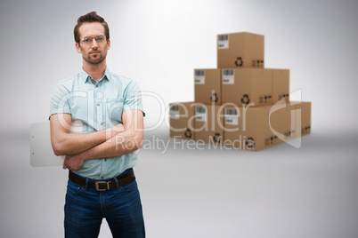Composite 3d image of serious warehouse manager standing with arms crossed
