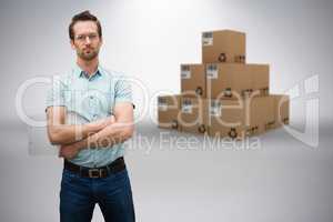 Composite 3d image of serious warehouse manager standing with arms crossed