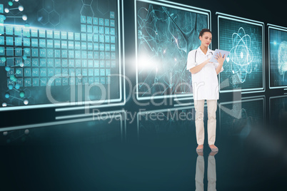 Composite 3d image of pretty nurse using tablet pc