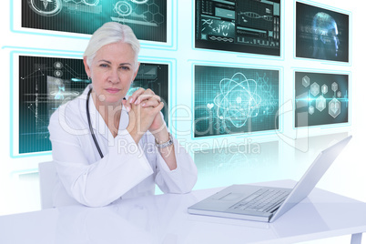 Composite 3d image of portrait of confident female doctor with laptop on desk