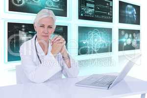 Composite 3d image of portrait of confident female doctor with laptop on desk
