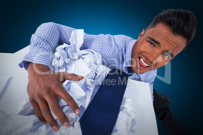 Composite image of portrait of unhappy businessman with crumpled paper