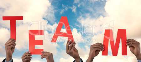 Composite image of cropped hand of businessman holding alphabet a