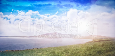 Scenic view of grassy field against sky