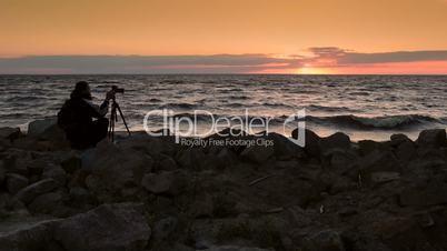 Skillful photograper shooting sea in twilight time