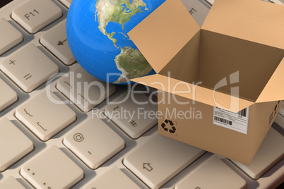 Composite image of 3d image of globe by empty cardboard box