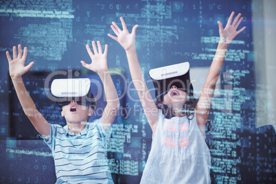 Siblings using virtual reality 3d headset in living room