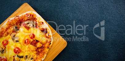 Pizza on wooden plate