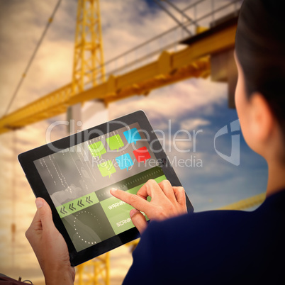 Composite 3d image of businesswoman working on digital tablet over white background