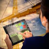 Composite 3d image of businesswoman working on digital tablet over white background