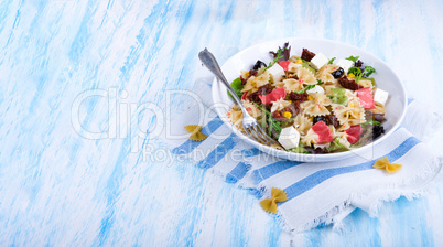 Mediterranean Farfalle salad with dry tomatoes and pine cores