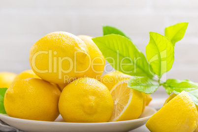 Fresh lemons with lemon leaves