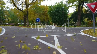 Aerial footage of road signs for the cyclists in autumn park