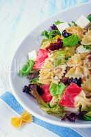 Mediterranean Farfalle salad with dry tomatoes and pine cores