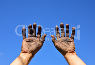 Two male hands raised up