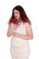 Woman in white dress and rose.