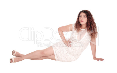 Young woman sitting on floor.