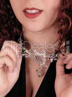 Closeup of necklace on a woman.