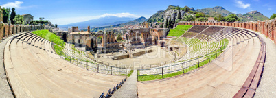 view of the ancient theater in Taormina with volcano Etna in the