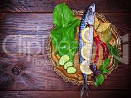 Mackerel with spices and herbs on a copper plate