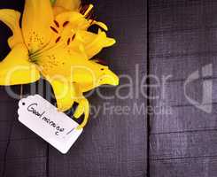 Yellow lily and a paper tag