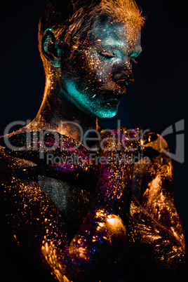 Portrait of a man painted in fluorescent UV colors.