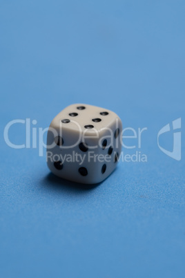 White cubic dice over blue