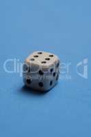White cubic dice over blue