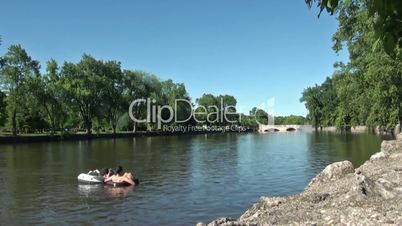 Swimming on inflatable circles on the cold river