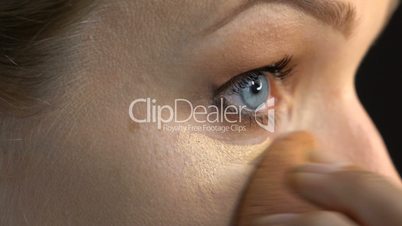Woman's face applying makeup