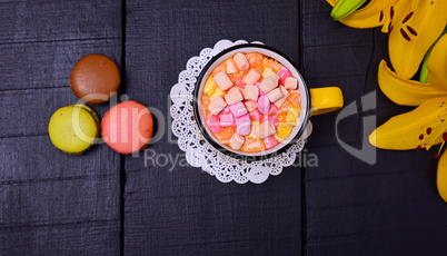 Hot chocolate with marshmallows on a black wooden background, to
