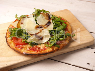 Tasty pizza on wooden board